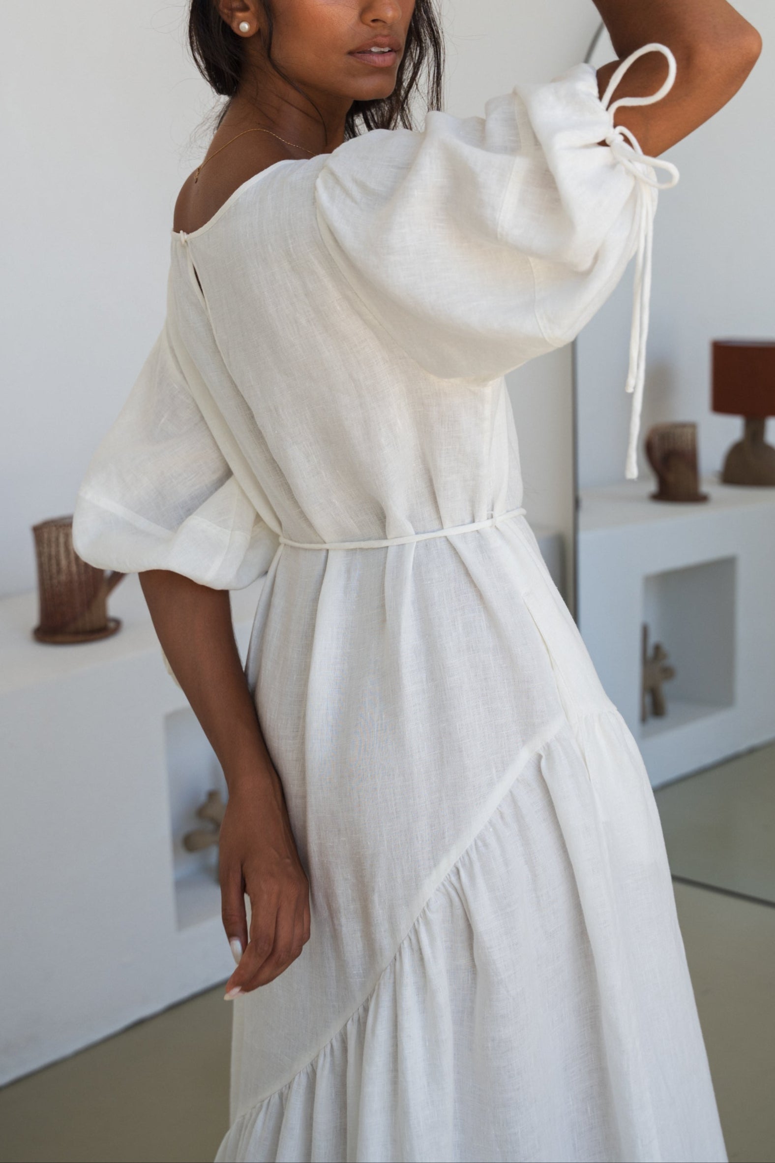 LILLY PILLY woman wearing Charlotte linen dress in Ivory showing sleeve details