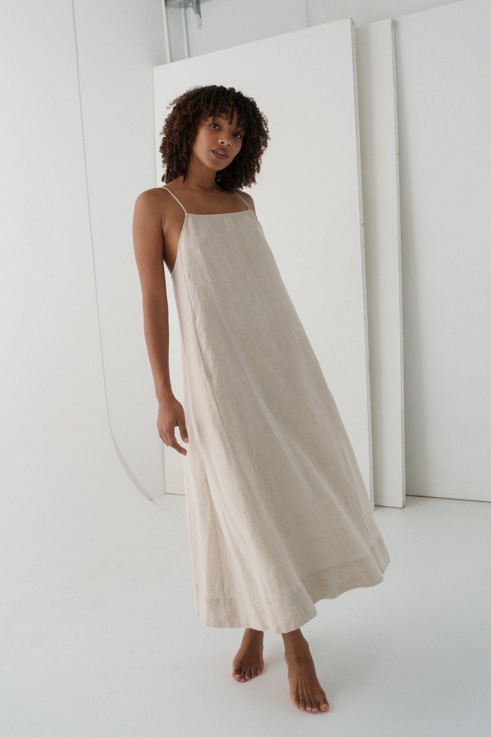 LILLY PILLY woman wearing a oatmeal Coco linen dress showing front view with a white background