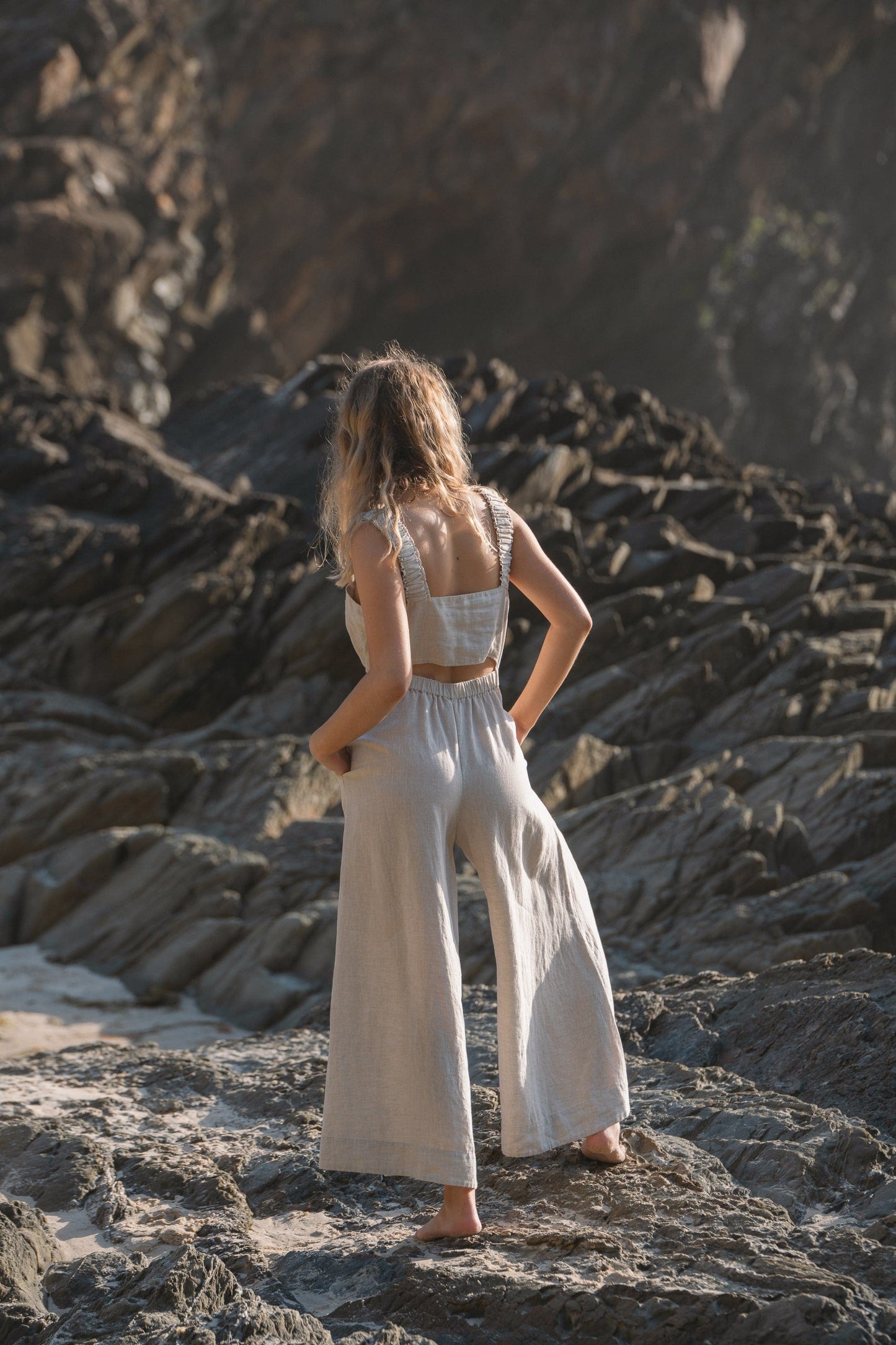 Lilly Pilly Collection European linen Keely jumpsuit in Oatmeal back view walking away
