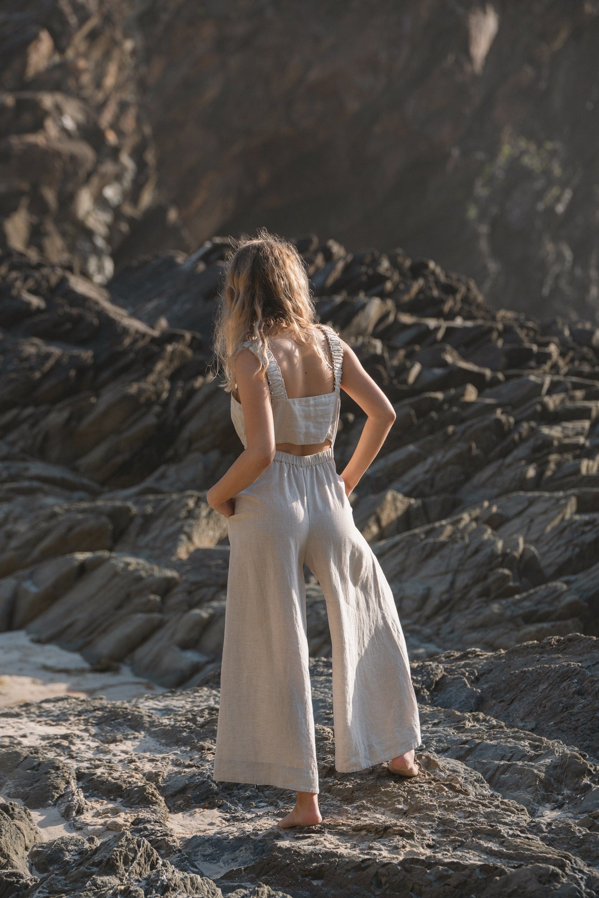 Lilly Pilly Collection European linen Keely jumpsuit in Oatmeal back view walking away
