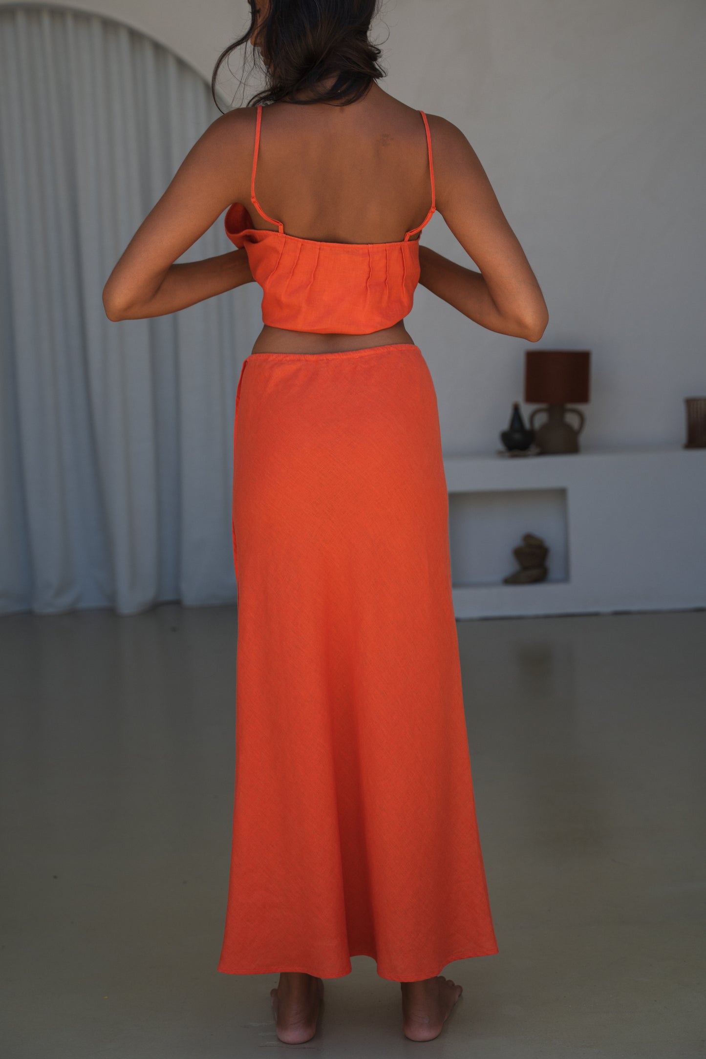 LILLY PILLY woman wearing Riley linen skirt in Spritz, back view