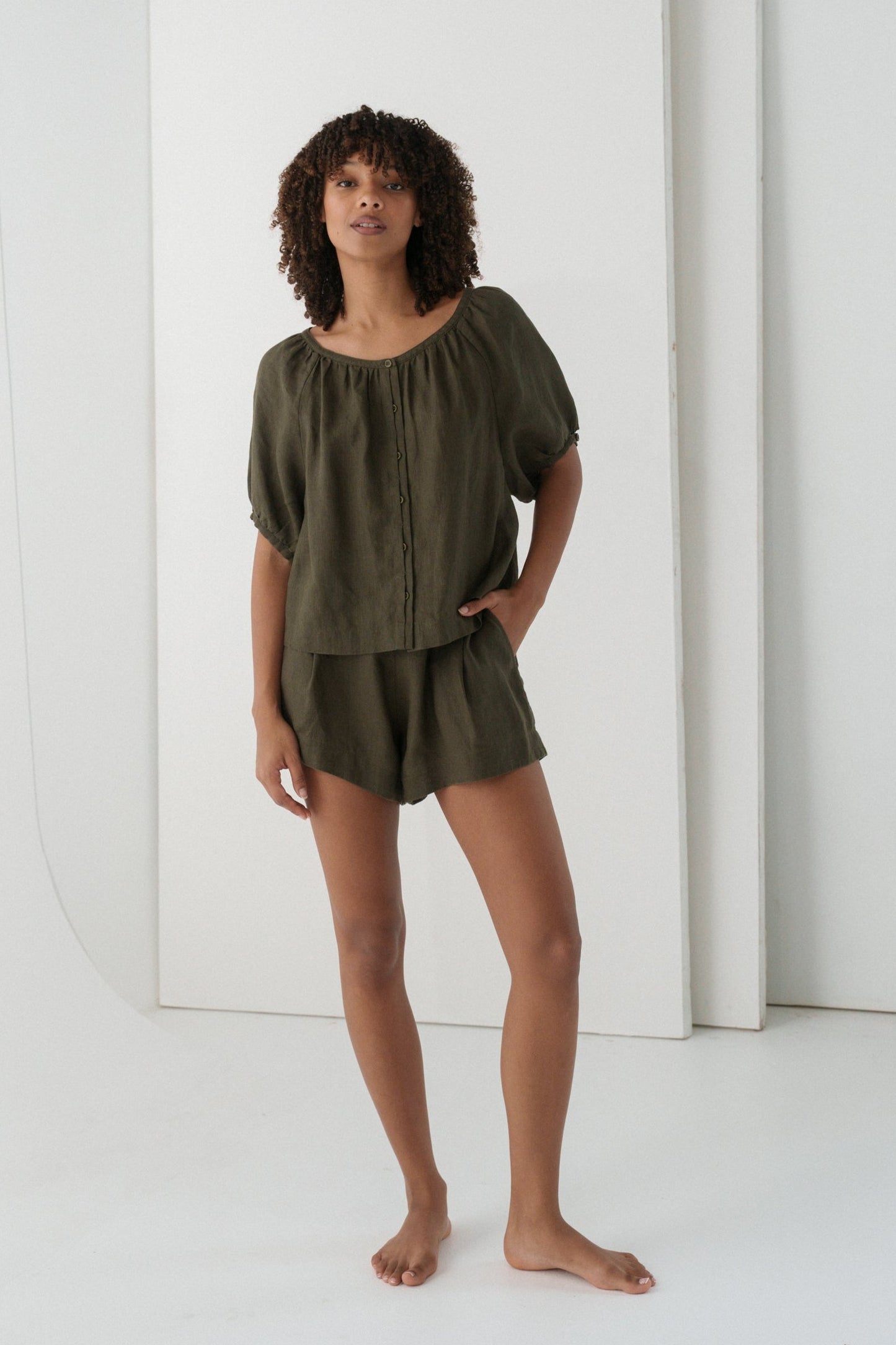 LILLY PILLY woman wearing a khaki Pia linen shirt top and Gaia shorts  outfit against a white background