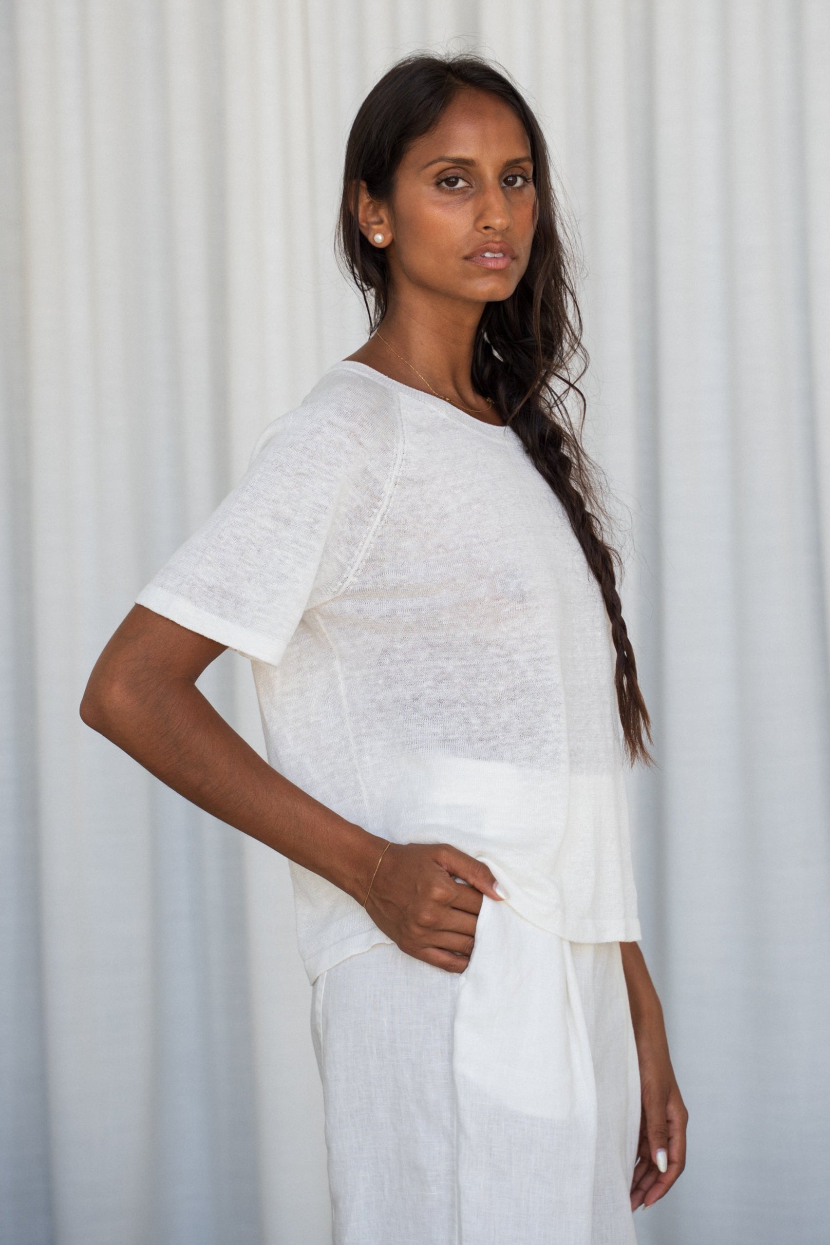 Person wearing a Grace knit top in Ivory side view