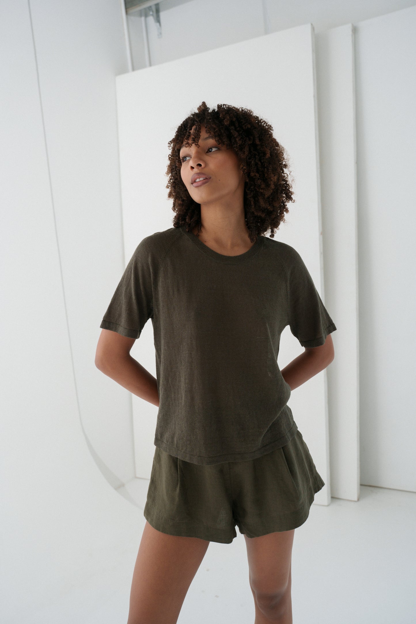 Woman wearing a khaki Grace linen knit top