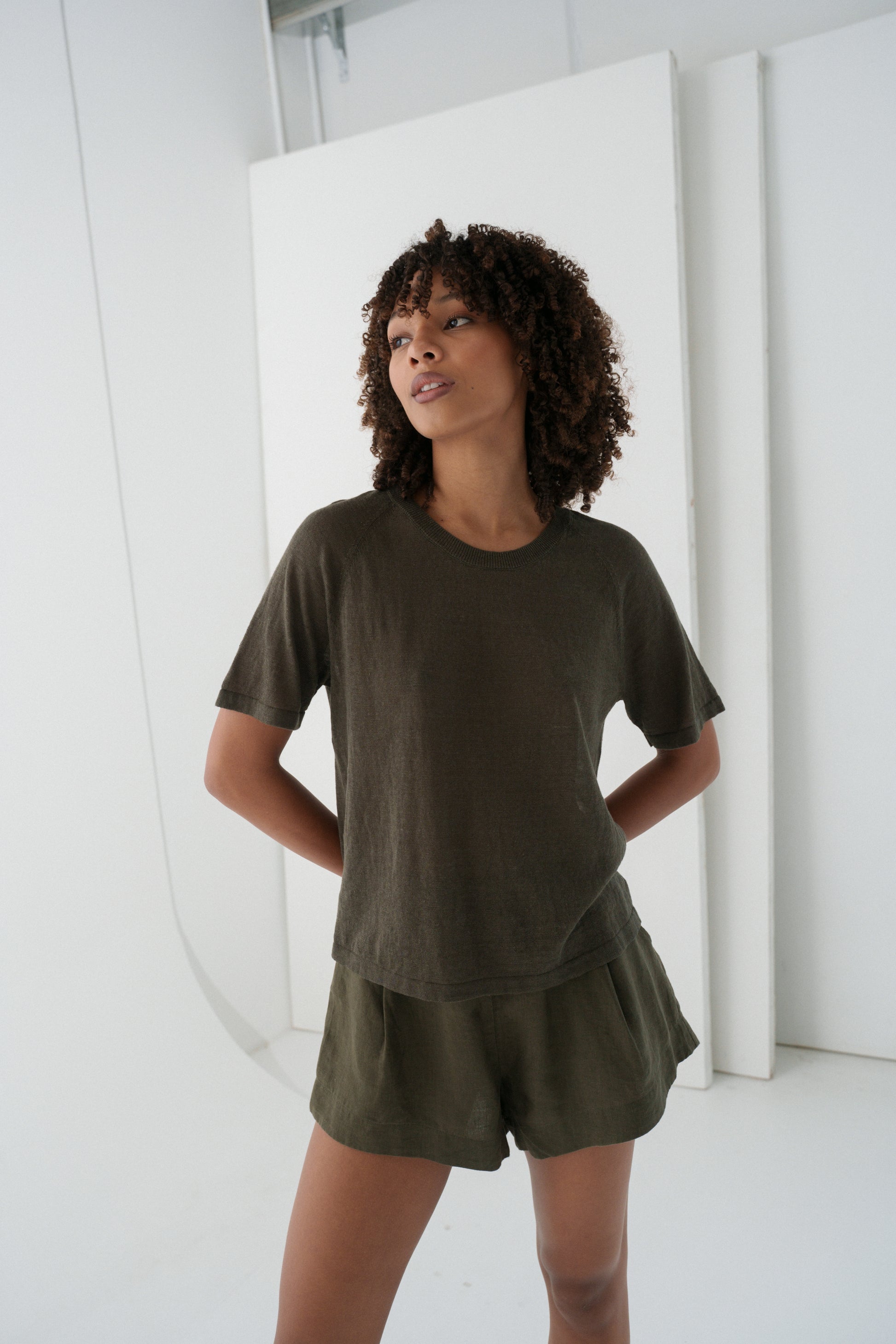 Woman wearing a khaki Grace linen knit top