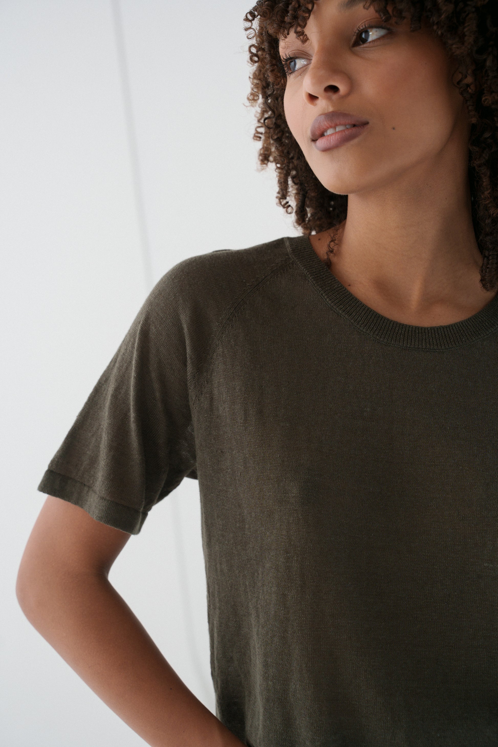 Woman wearing a khaki Grace linen knit top close up