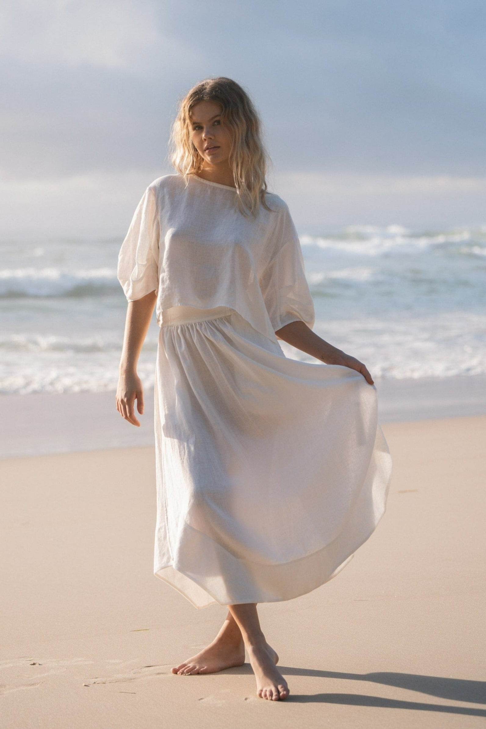 Lilly Pilly Collection Hannah skirt made from European linen in Ivory with Tina linen top in Ivory on the beach